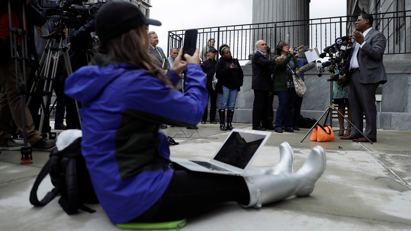Wyatt, right, speaks to the media outside the Montgomery County Courthouse.